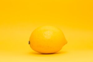 yellow lemon fruit on white surface