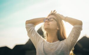 photo of woman holding her head