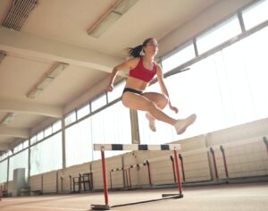 photo of a woman jumped on obstacle