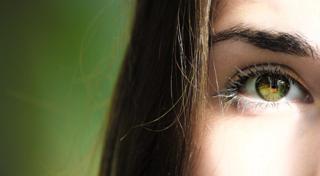 selective focus half face closeup photography of female s green eyes