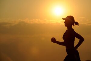 woman with white sunvisor running