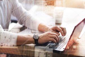 Close up of male hands typing on laptop keyboard