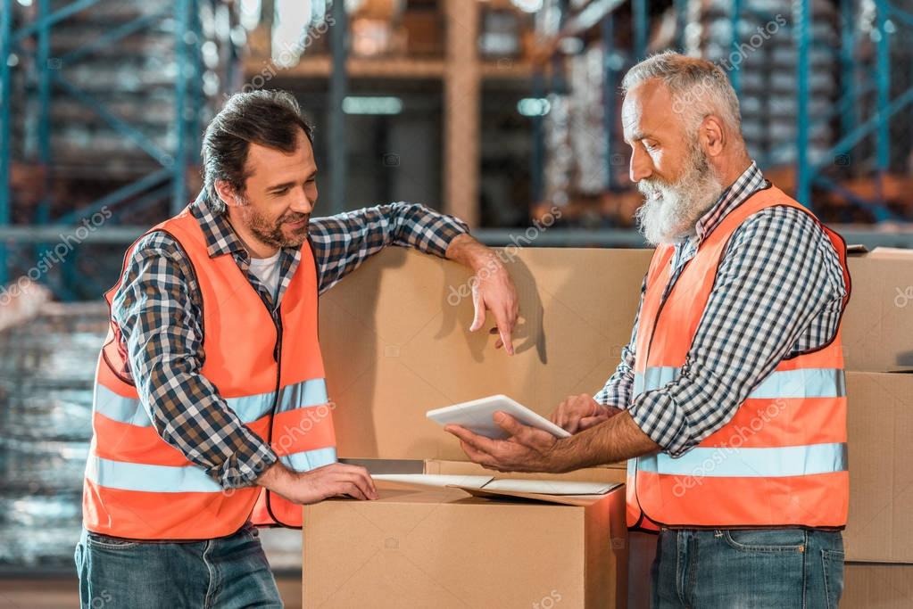 warehouse workers with digital tablet