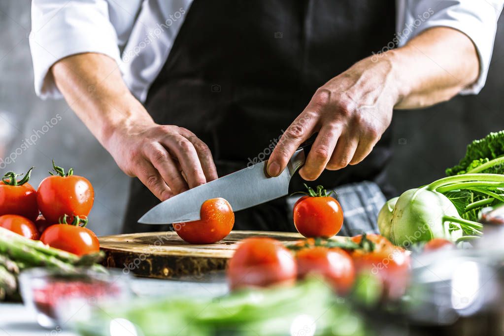 Chef cook preparing vegetables in his kitchen