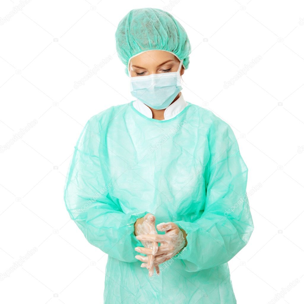 Female surgeon washing her hands