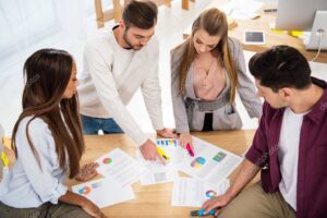 multiethnic business colleagues discussing new marketing project at workplace in office