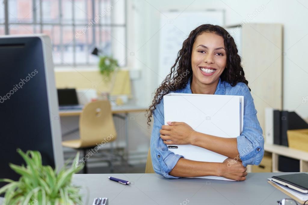 successful smiling woman holding a white binder