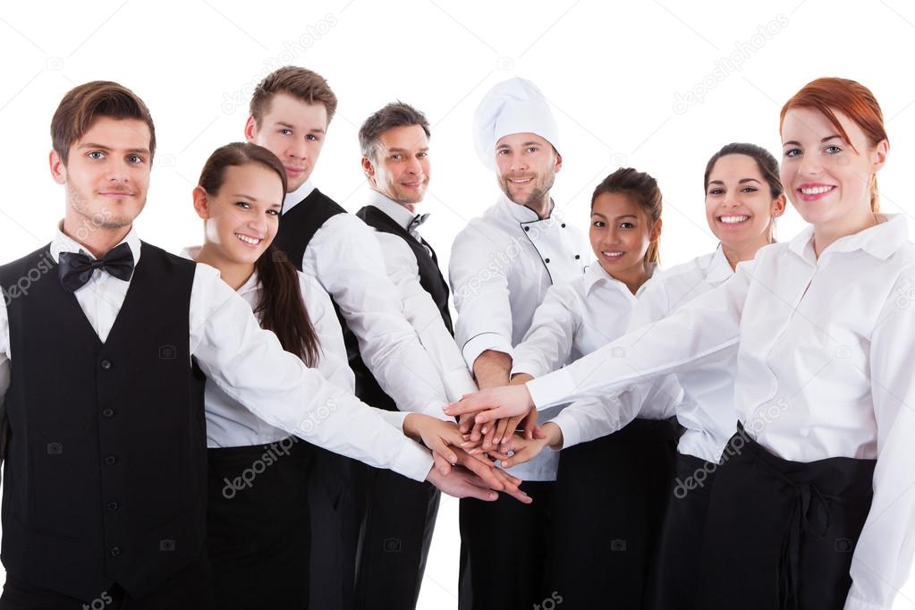 Waiters and waitresses stacking hands