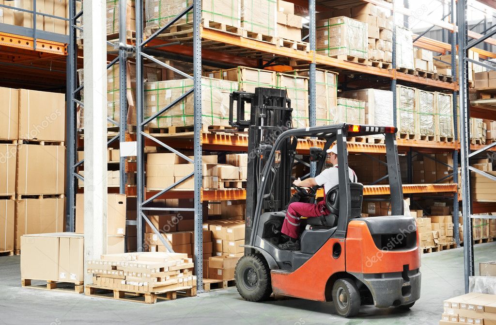 Worker driver at warehouse forklift loader works