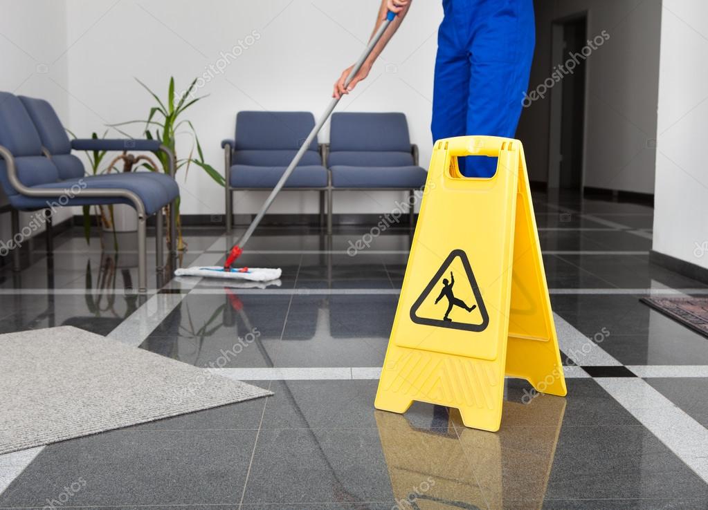 Man With Mop And Wet Floor Sign