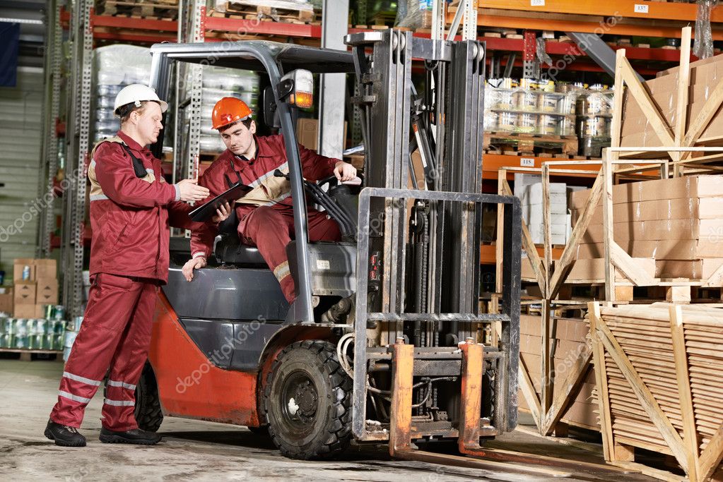 Warehouse workers in front of forklift