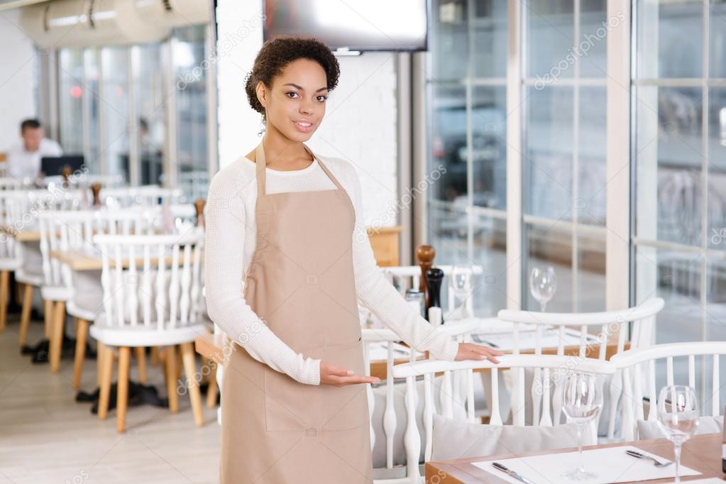 Waitress offering a seat.