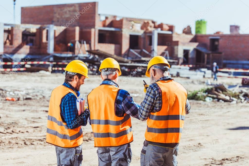 Three workers at construction site