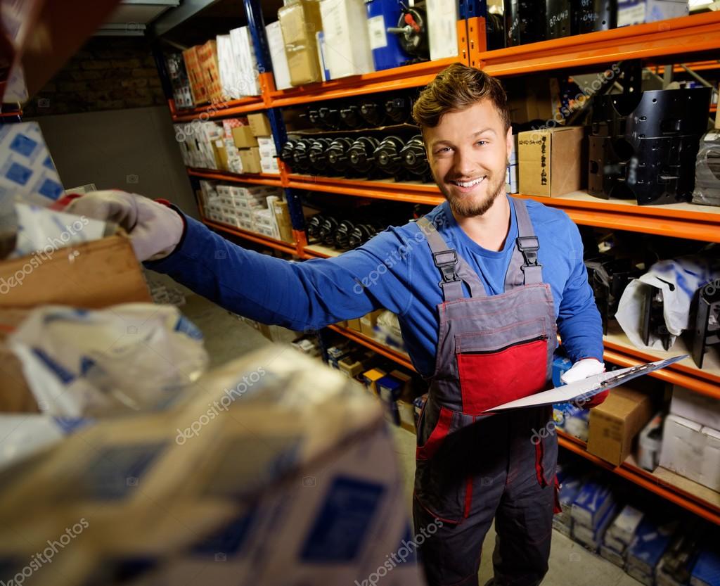 Worker on a automotive spare parts warehouse