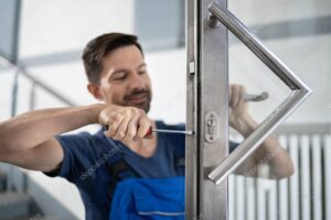 Portrait Young Male Carpenter Repairing Door Lock